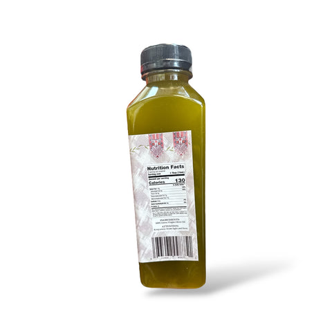 a bottle of green juice on a white background