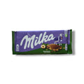 Milka Hazelnut Chocolate with Broken Hazelnuts packaging showcasing the rich chocolate and nutty flavors, ideal for chocolate lovers, available at ALBASHA Store.