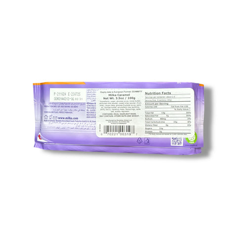 Back view of the Milka Chocolate Bar with Creamy Caramel Filling, displaying nutritional facts and ingredients, available at ALBASHA Store.