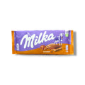 Milka Chocolate Bar with Creamy Caramel Filling packaging featuring the Milka logo and a cow, available at ALBASHA Store.