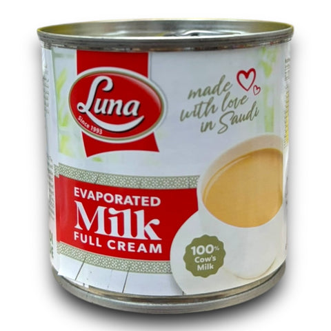 a can of milk with a spoon in it