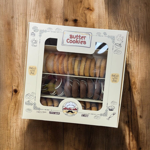 A beautifully packaged box of assorted sweet butter cookies from Albasha. This gift features a variety of fresh baked, crafted cookies, perfect for celebrations like Valentine's Day. The charming design highlights the delightful assortment, making it an ideal treat for cookie lovers. Butter cookies, Cookies.