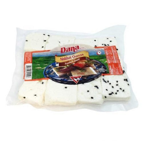 Package of Dana Nablus Cheese featuring white cheese slices with black sesame seeds, displayed on a blue plate with scenic landscape background.