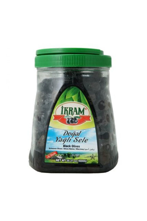 Ikram Black Olives jar featuring a green lid and a label in multiple languages including English. The jar contains natural black olives and is prominently labeled with the product name and weight, suitable for culinary use.