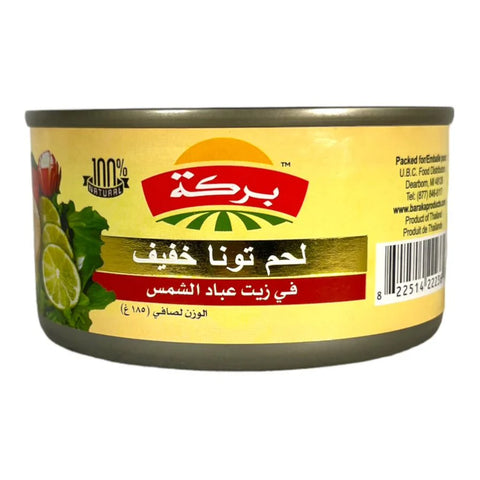 Baraka Light Meat Tuna in Sunflower Oil, featuring a can with colorful branding and product information in Arabic and English, highlighting its natural ingredients and weight of 185 grams.