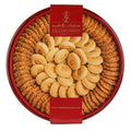 An elegant close-up of a round red tin containing Zalatimo Sweets, displaying an array of sesame and butter cookies. The cookie assortment is meticulously presented, highlighting the rich colors and textures of the cookies, making it an enticing treat for celebrations and gifts.