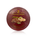 A packaged round tin of Zalatimo Sweets labeled 'Original Levantine Sesame and Butter Cookies'. The tin is predominantly red with a gold logo and features pictures of the cookies, emphasizing their irresistible taste. This packaging is elegant and suggests a premium product suitable for any dessert table.